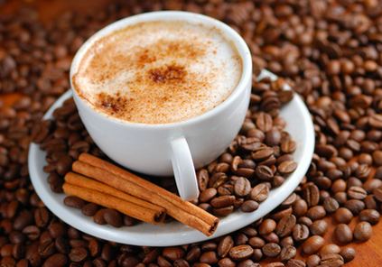 A cup of cappuccino on coffee beans