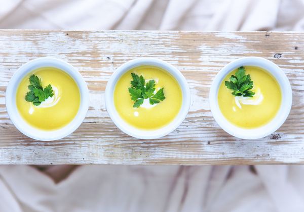 Three bowls of creamy soup
